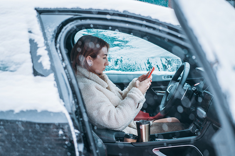 woman driver sitting behind the steering wheel in her car
