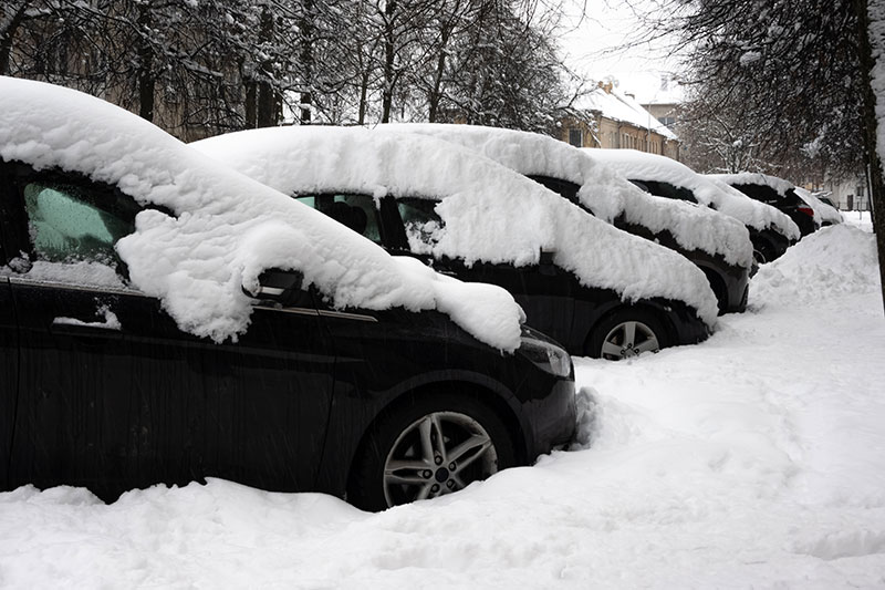 Cars under thick blanket of snow